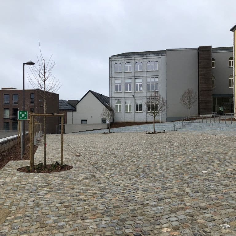 Application image for Reclaimed European Sandstone Cobblestones - Rectangle - Worn Surface. The image shows this product being used for patio pavers and public area. The surface finish shown is . The dominant color shown is gray. The color mix creates a warm feeling.