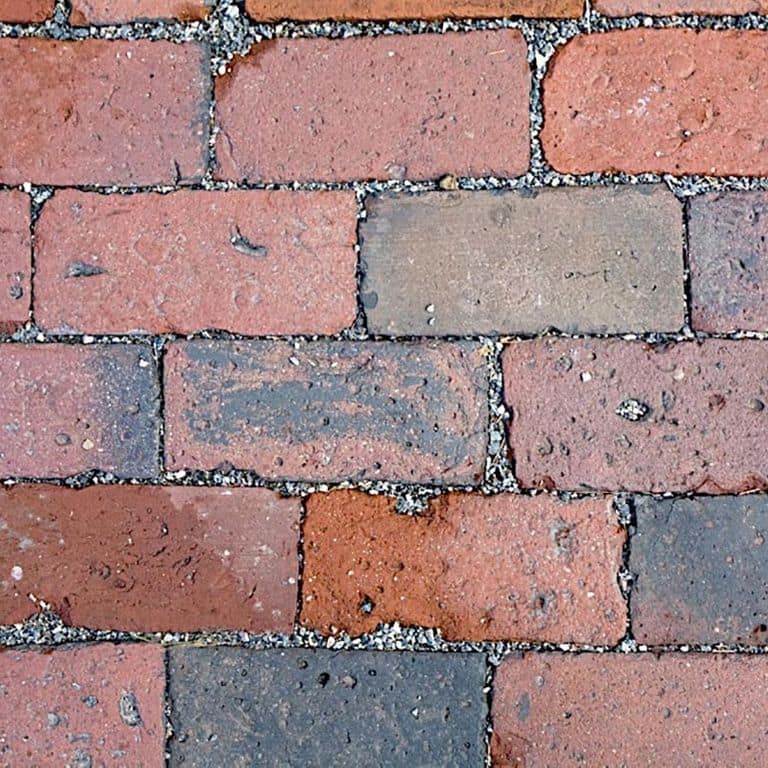 Best close-up image for Reclaimed Boston Brick Pavers. The image shows this product being used for driveway pavers, path pavers, patio pavers and driveway aprons. The surface finish shown is . Dominant colors shown are gray, pink and red; with blue, brown and orange/rust secondaries. The color mix creates a warm feeling. Regular color pattern.