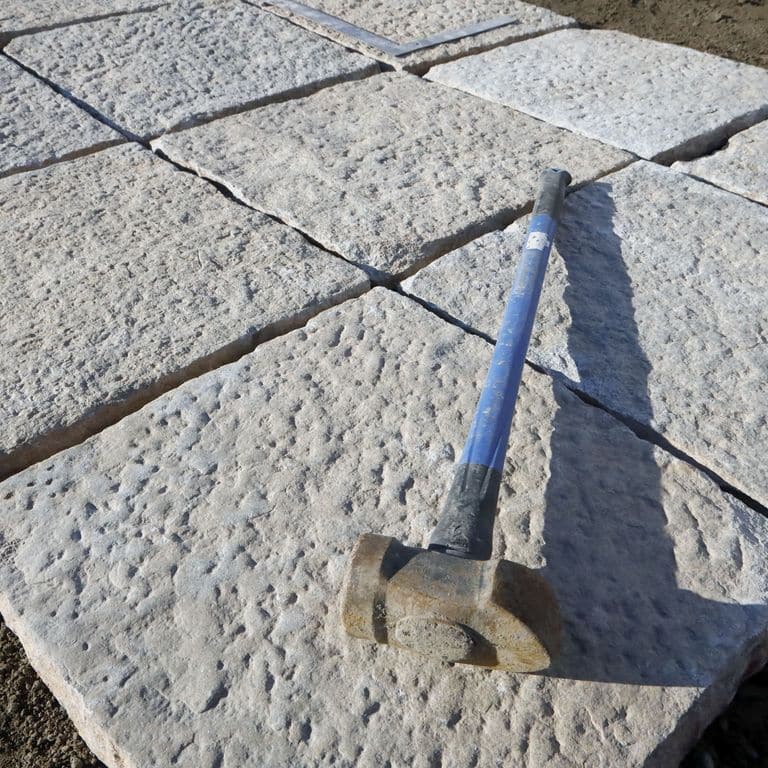 Application image for Granite - Reclaimed Pavers - Squares. The surface finish shown is . The dominant color shown is gray. The color mix creates a cool feeling. Regular color pattern.