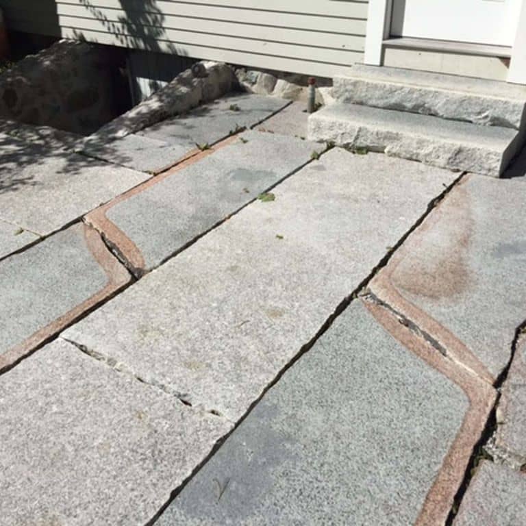Close-up image for Reclaimed Granite Pavers - Live Edge. The surface finishes shown are flamed and sawn. The dominant color shown is gray; with beige, white, tan and cream secondaries. Speckled, fine speckled and blotched color patterns.