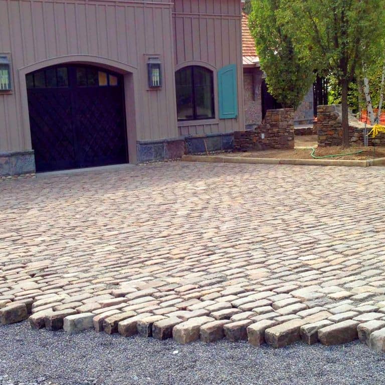 The image shows this product being used in a driveway pavers application.