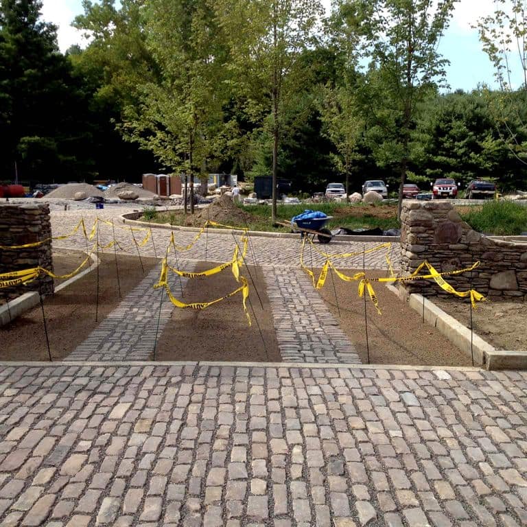 The image shows this product being used in a driveway pavers application.