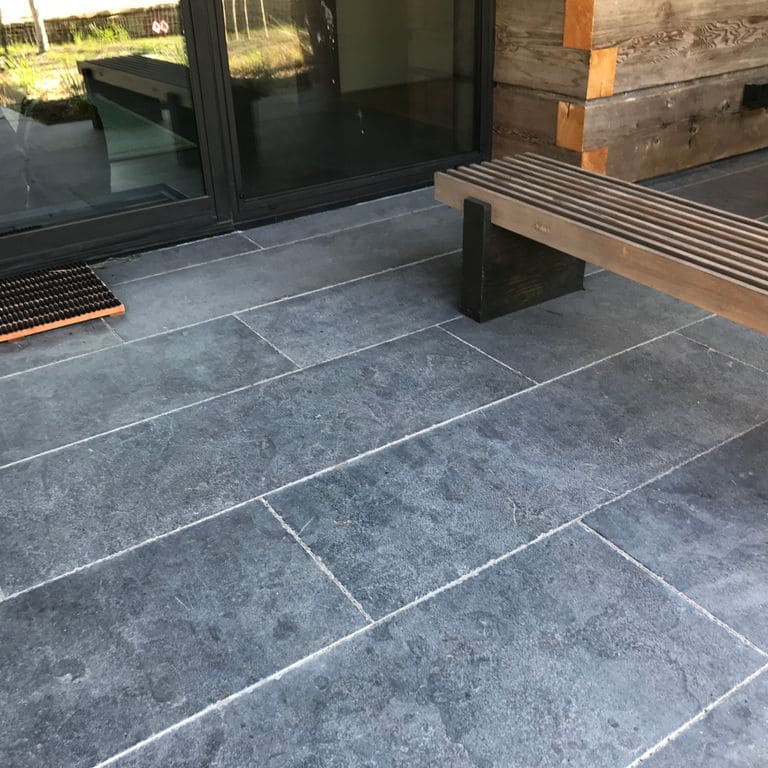 The image shows this product being used in a patio pavers application.