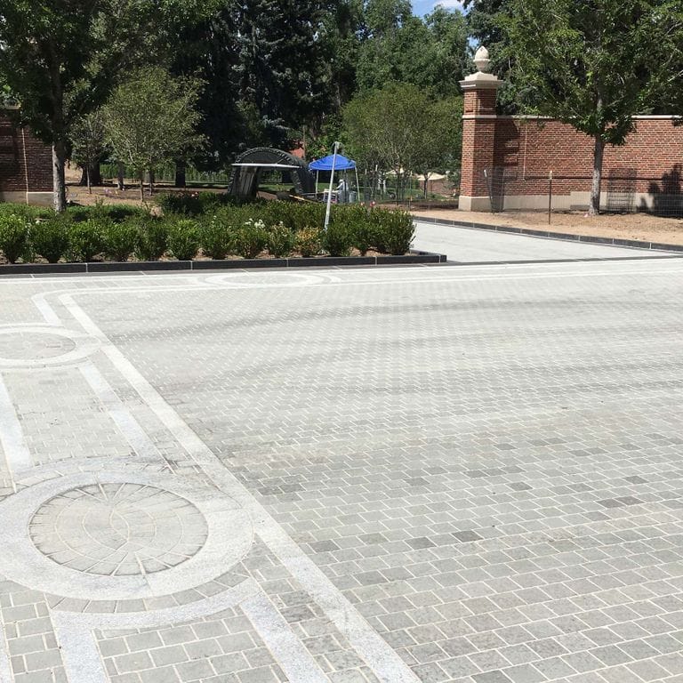 The image shows this product being used for patio pavers and driveway aprons.