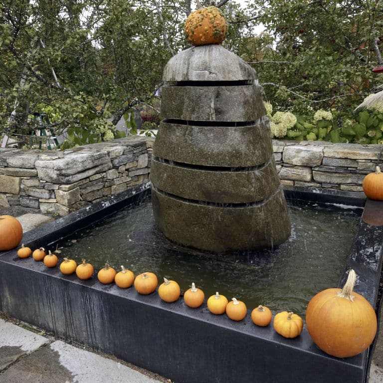Application image for New England Fieldstone Boulders &amp; Ledgestone - Fountains &amp; Lights. The image shows this product being used for water features and garden accents. The surface finish shown is weathered. The dominant color shown is gray.