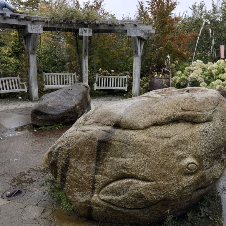 Application image for New England Fieldstone Boulders &amp; Ledgestone - Fountains &amp; Lights. The image shows this product being used for water features and garden accents. The surface finish shown is weathered. The dominant color shown is gray.