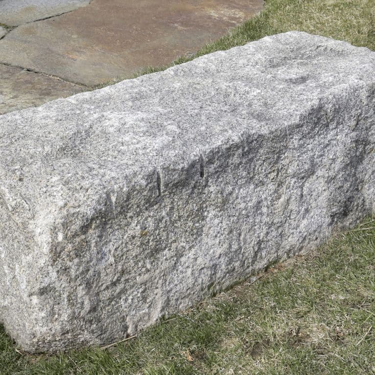 Close-up image for Reclaimed Granite Bridge Blocks - Benches and Seating. The surface finishes shown are weathered and worn. Dominant colors shown are gray and white. Exhibits "movement" and the color mix creates a cool feeling. Speckled, blotched and cloudy color patterns.