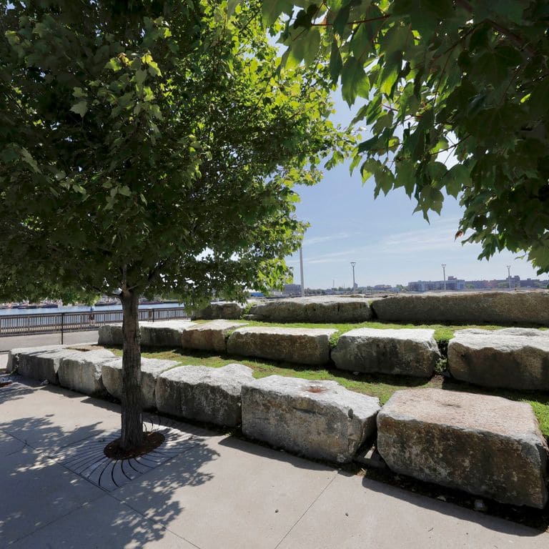 Application image for Reclaimed Granite Bridge Blocks - Benches and Seating. The image shows this product being used for seating &amp; benches and landscape wallstone. The surface finish shown is . Dominant colors shown are brown and gray. Regular color pattern.