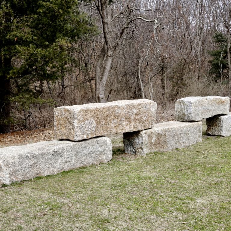 Application image for Reclaimed Granite Bridge Blocks - Benches and Seating. The image shows this product being used for garden accents and seating &amp; benches. The surface finish shown is . The dominant color shown is gray. The color mix creates a warm feeling. Fine speckled color pattern.
