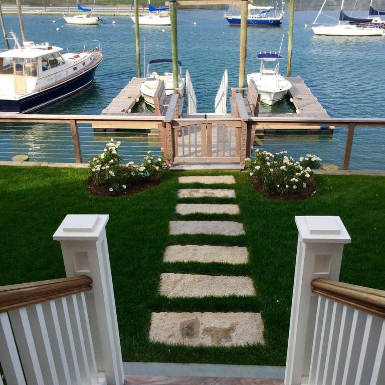 Application image for Reclaimed Rustic Granite - Plank Pavers. The image shows this product being used in a path pavers application. The surface finish shown is . The dominant color shown is gray. The color mix creates a warm feeling.