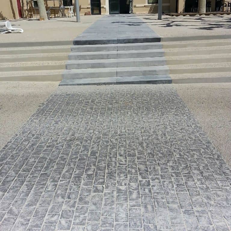 The image shows this product being used in a driveway pavers application.