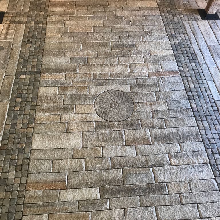 The image shows this product being used in a driveway pavers application.