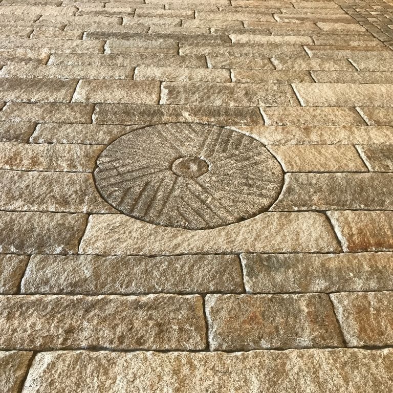 The image shows this product being used in a driveway pavers application.