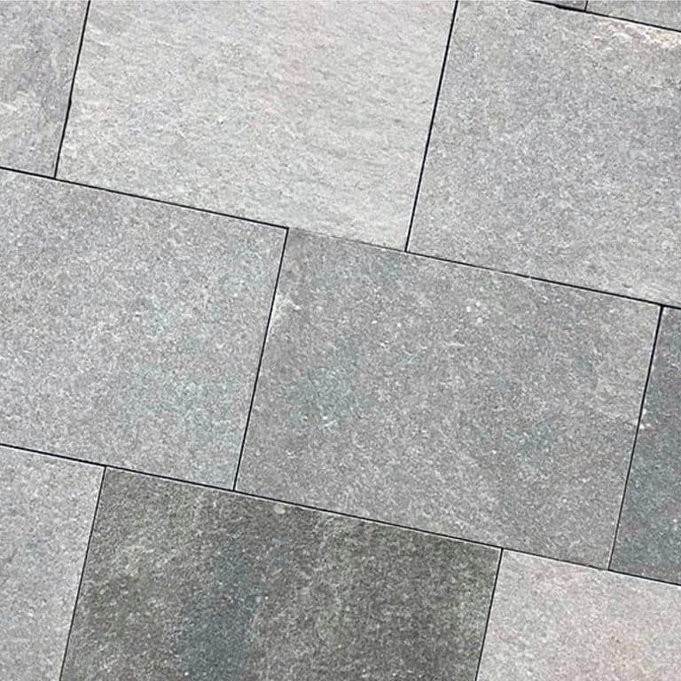 Close-up image for Greek Quartzite Slate - Grey - Dimensional Sawn Pavers. The dominant color shown is gray; with beige, pink, purple and white secondaries. Exhibits "movement" and the color mix creates a cool feeling. Speckled, fine speckled and cloudy color patterns.