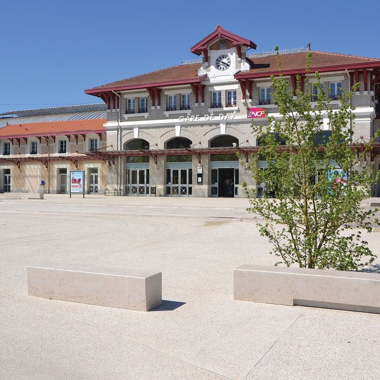 Feature image for Limestone - Classimo Beige Pavers. The image shows this product being used in a public area application. Dominant colors shown are beige, gray, white and cream. Speckled color pattern.