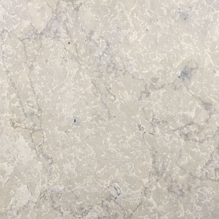 Swatch image cropped for Sky Prima Limestone - Veneer. The surface finishes shown are brushed and flamed. Dominant colors shown are beige, gray and cream; with pink, white and tan secondaries. Exhibits "movement". Blotched, veined and swirled color patterns.