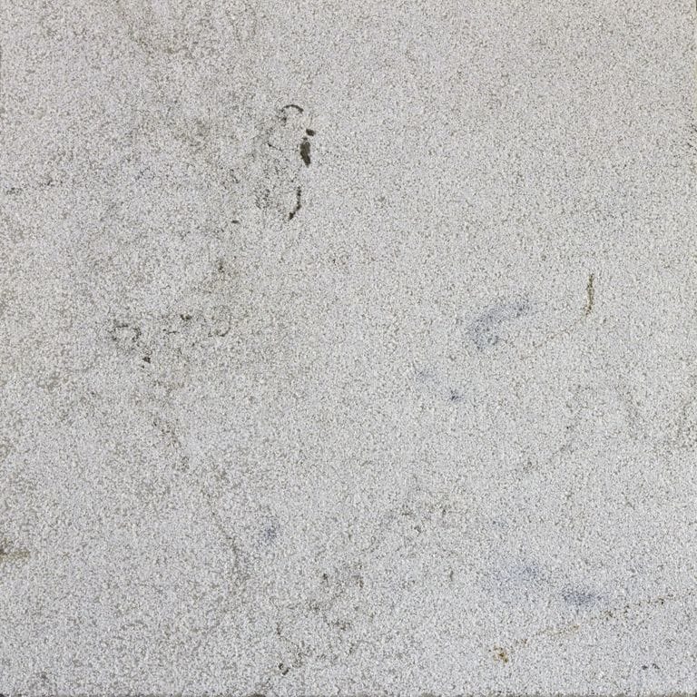Close-up image for Sky Prima Limestone Cobblestones. The dominant color shown is gray; with beige and white secondaries. Exhibits "movement" and the color mix creates a cool feeling. Regular, fine speckled and cloudy color patterns.