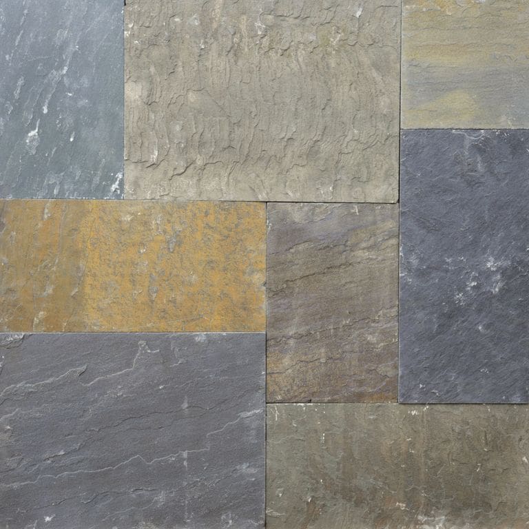 Close-up image for Bluestone Natural Cleft Full Color Mix - Dimensional Cut Pavers. The surface finish shown is natural cleft. Dominant colors shown are green and gray; with blue, brown, orange/rust, purple and tan secondaries. Exhibits "movement" and the color mix creates a warm feeling. Random color pattern.