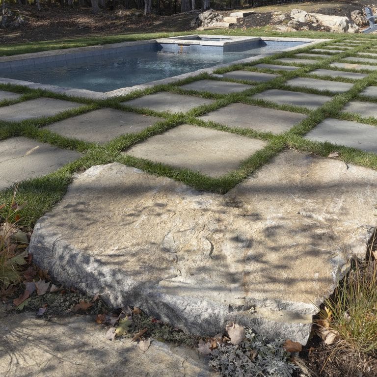 Application image for Full Color Bluestone - Natural Cleft Dimensional Cut Pavers. The image shows this product being used in a pool coping application. The surface finish shown is natural cleft. The dominant color shown is gray. The color mix creates a warm feeling.