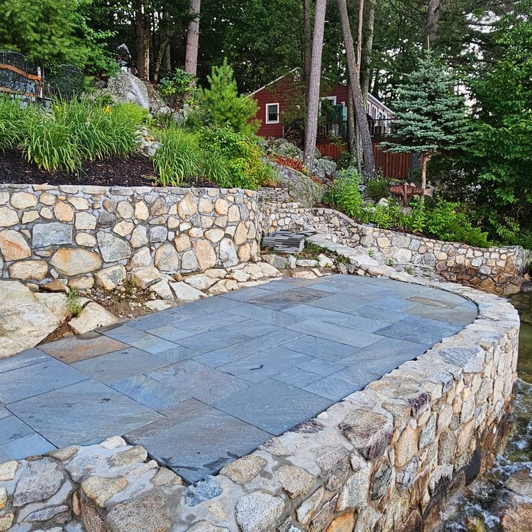 Application image for Bluestone Natural Cleft Full Color Mix - Dimensional Cut Pavers. The image shows this product being used in a patio pavers application. The surface finish shown is natural cleft. Dominant colors shown are blue and gray. The color mix creates a cool feeling.