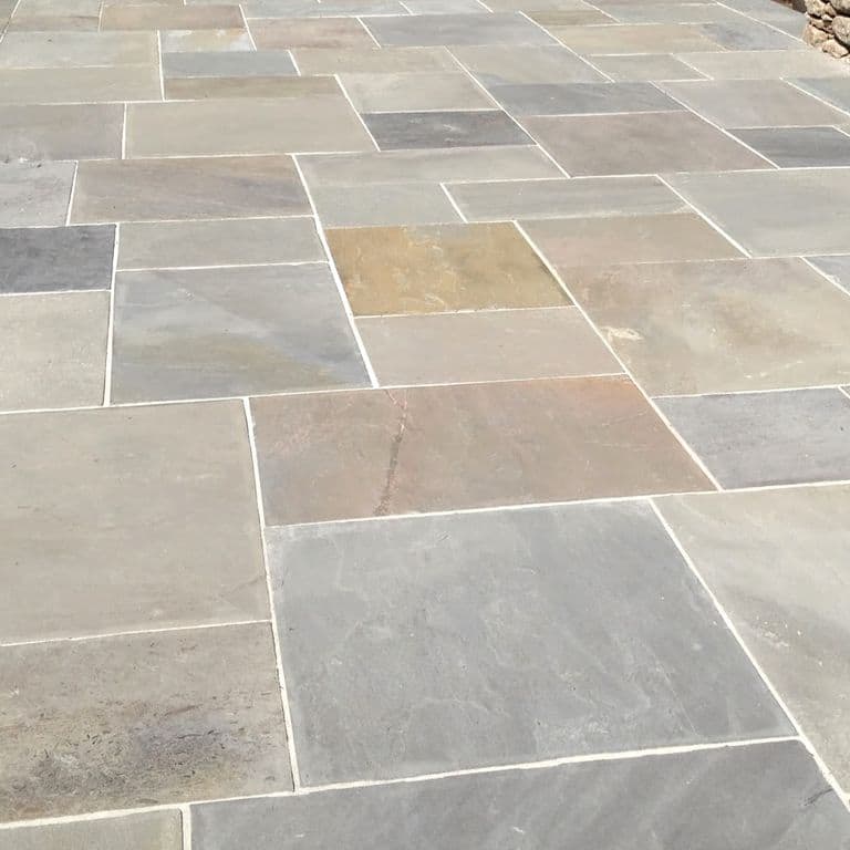 The image shows this product being used in a patio pavers application.