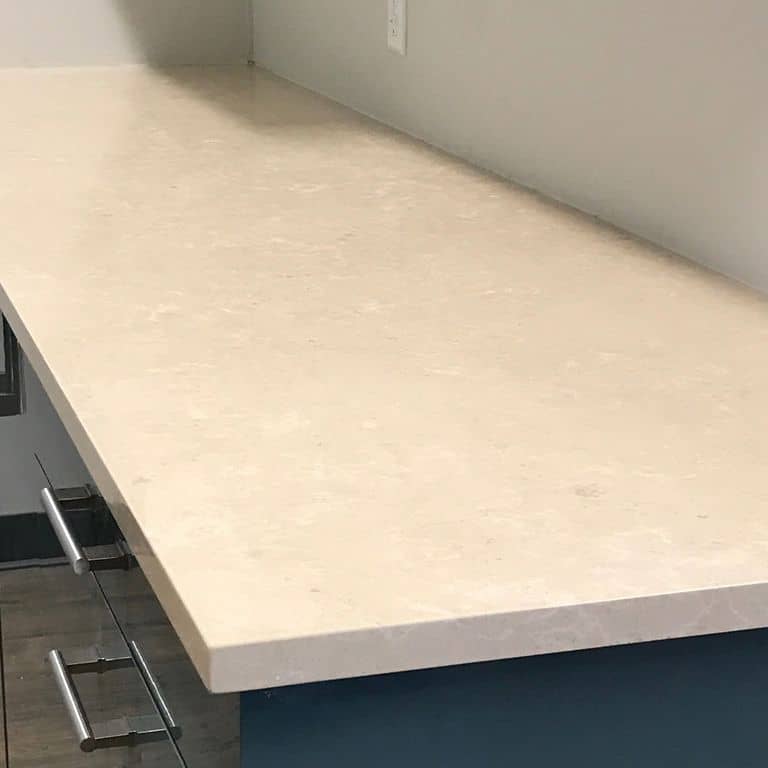 Close-up image for Mountain Hard Limestone Beige - Countertop Slabs. The surface finish shown is polished. Dominant colors shown are beige, tan and cream; with gray and white secondaries. Exhibits "movement" and the color mix creates a warm feeling. Regular, marbled, blotched and cloudy color patterns.