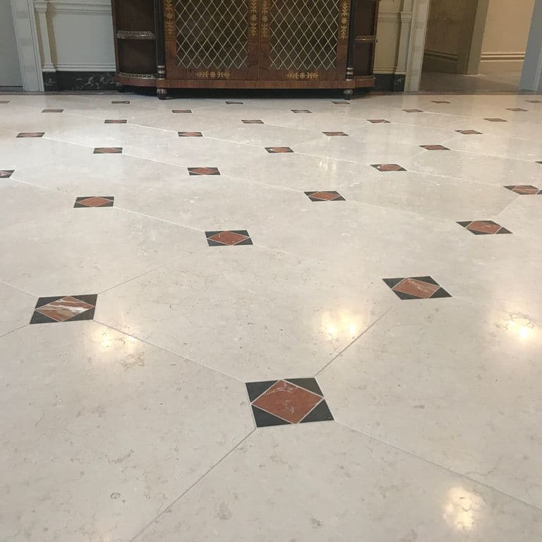 Close-up image for Mountain Hard Limestone Beige - Interior Flooring. The surface finish shown is polished. Dominant colors shown are beige and gray; with white, tan and cream secondaries. Exhibits "movement" and the color mix creates a warm feeling. Solid, regular, blotched and cloudy color patterns.