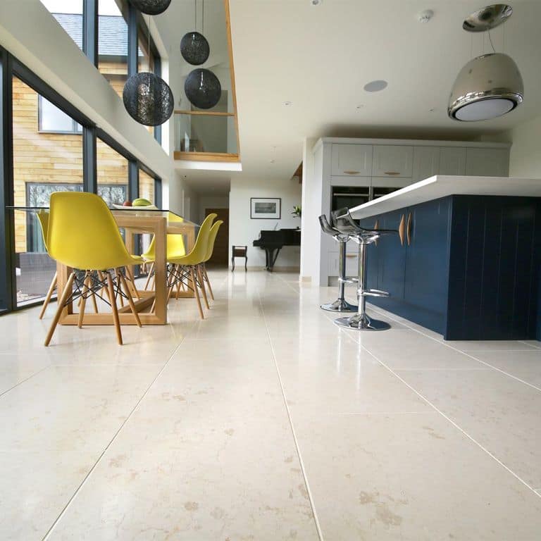 Feature image for Mountain Hard Limestone Beige - Interior Flooring. The image shows this product being used in an interior floor application. Dominant colors shown are beige, gray, white and cream; with a tan secondary. Exhibits "movement" and the color mix creates a warm feeling. Blotched and cloudy color patterns.