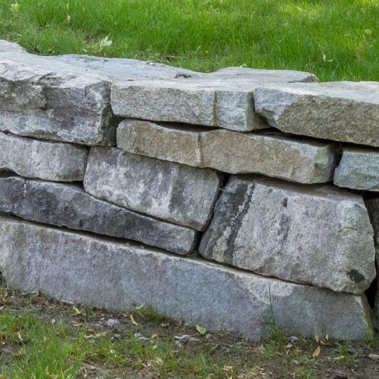 The image shows this product being used in a landscape wallstone application.