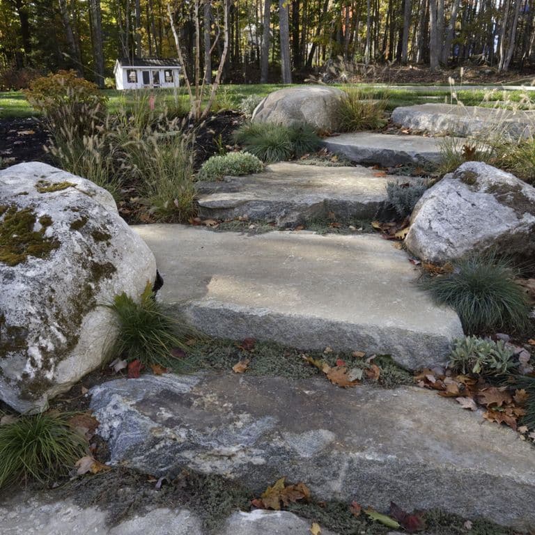 Application image for Granite - Black Mountain - Live Edge Steps. The image shows this product being used in a monolithic steps application. The surface finish shown is natural. The dominant color shown is gray. The color mix creates a warm feeling.