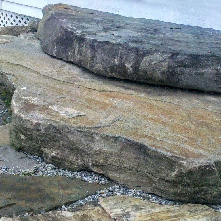 Close-up image for Mystic Mountain Natural - Steps &amp; Landings. The surface finish shown is natural. The dominant color shown is gray; with black, blue, brown, green, orange/rust, purple and tan secondaries. Exhibits "movement". Random, fine speckled, blotched, swirled and streaked color patterns.