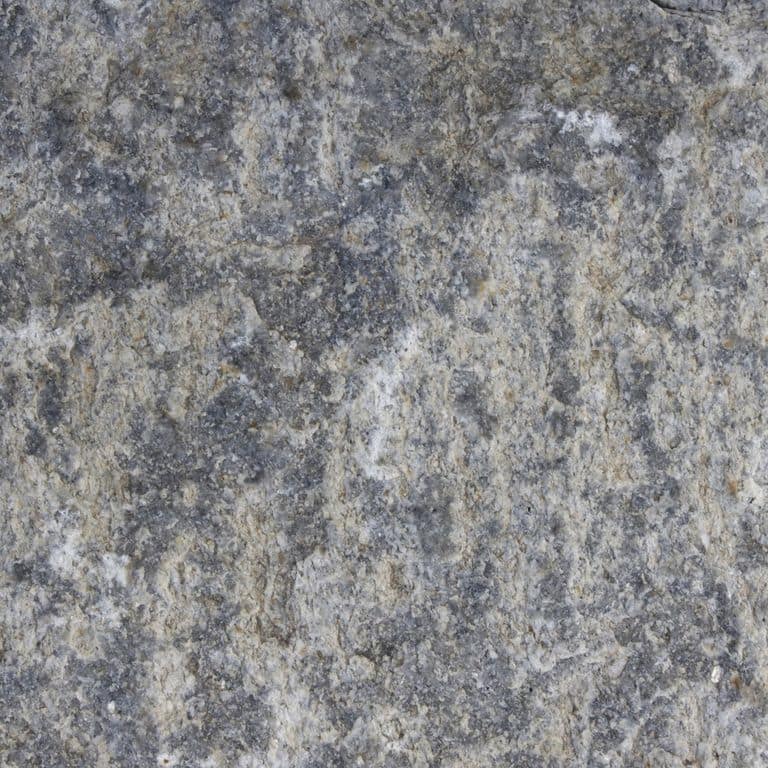 Color/Finish variation image for Reclaimed Granite Curbstone - Junior Wallstone. The dominant color shown is gray; with blue, brown, green, purple and white secondaries. Exhibits "movement". Speckled, blotched and swirled color patterns.