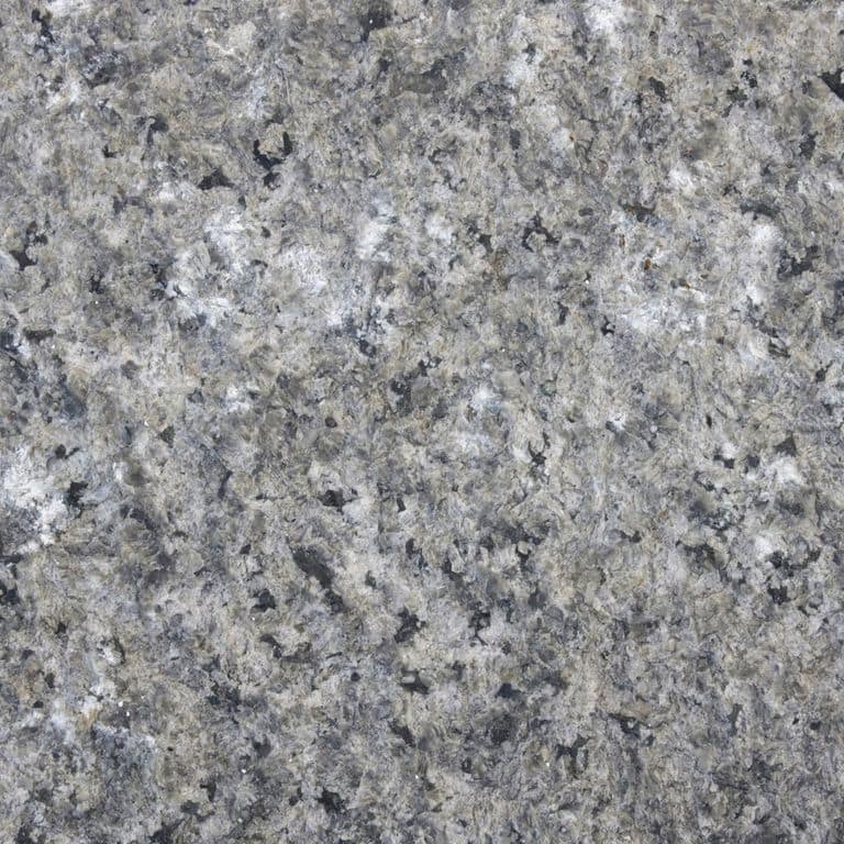 Color/Finish variation image for Reclaimed Granite Curbstone - Junior Wallstone. The dominant color shown is gray; with beige, green and white secondaries. The color mix creates a cool feeling. Coarse speckled color pattern.