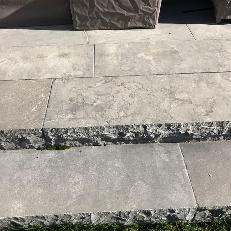 Application image for Highland Limestone - Steps. The image shows this product being used in a monolithic steps application. The surface finish shown is flamed. The dominant color shown is gray. The color mix creates a warm feeling.