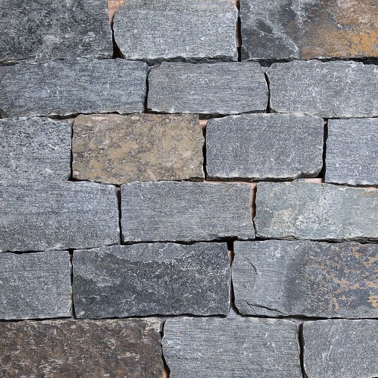 Color/Finish variation image for Blue Mountian Granite - Veneer. The surface finish shown is split-face. The dominant color shown is gray. The color mix creates a cool feeling.