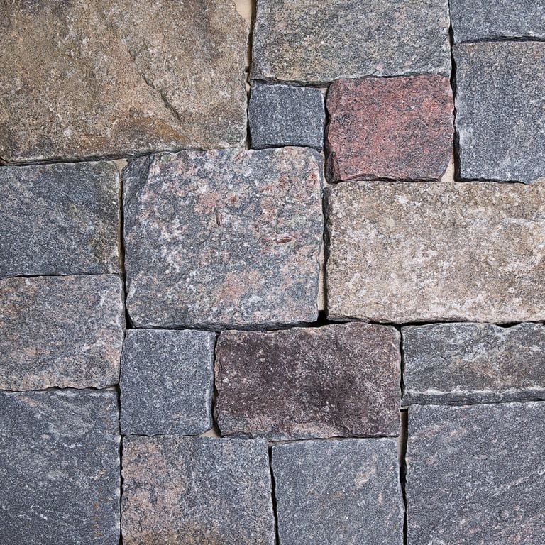 Close-up image for Hawthorne Granite - Veneer. The dominant color shown is gray; with beige, blue, brown, orange/rust, purple, white and tan secondaries. Exhibits "movement". Speckled and cloudy color patterns.