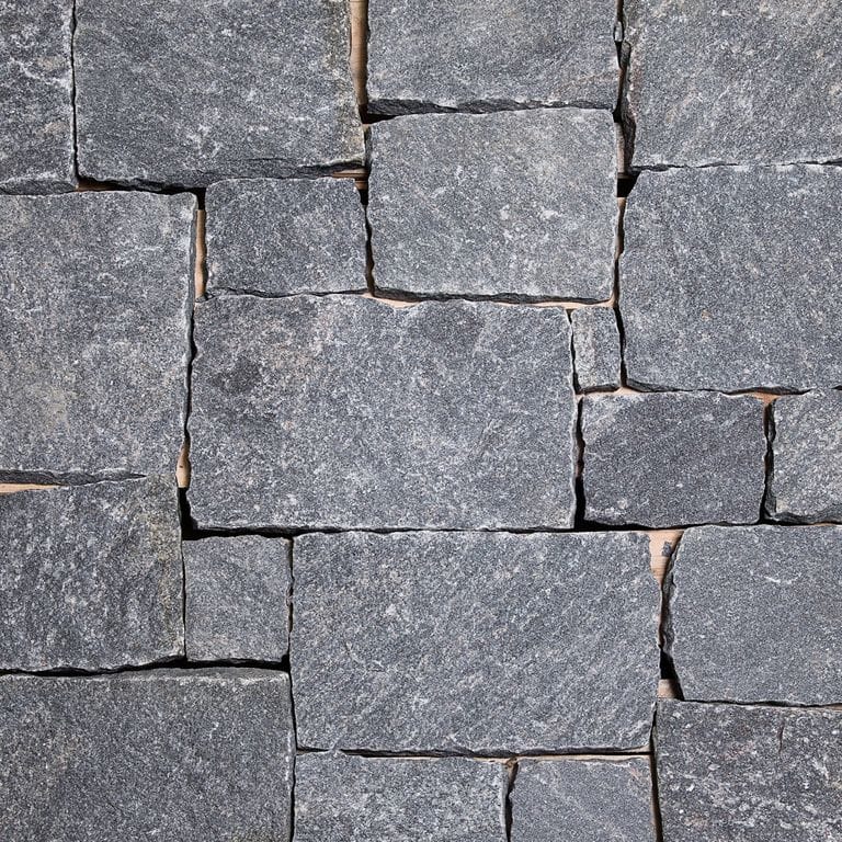 Close-up image for Heritage Granite - Wall Veneer. The dominant color shown is gray; with blue and purple secondaries. Exhibits "movement" and the color mix creates a cool feeling. Fine speckled and cloudy color patterns.
