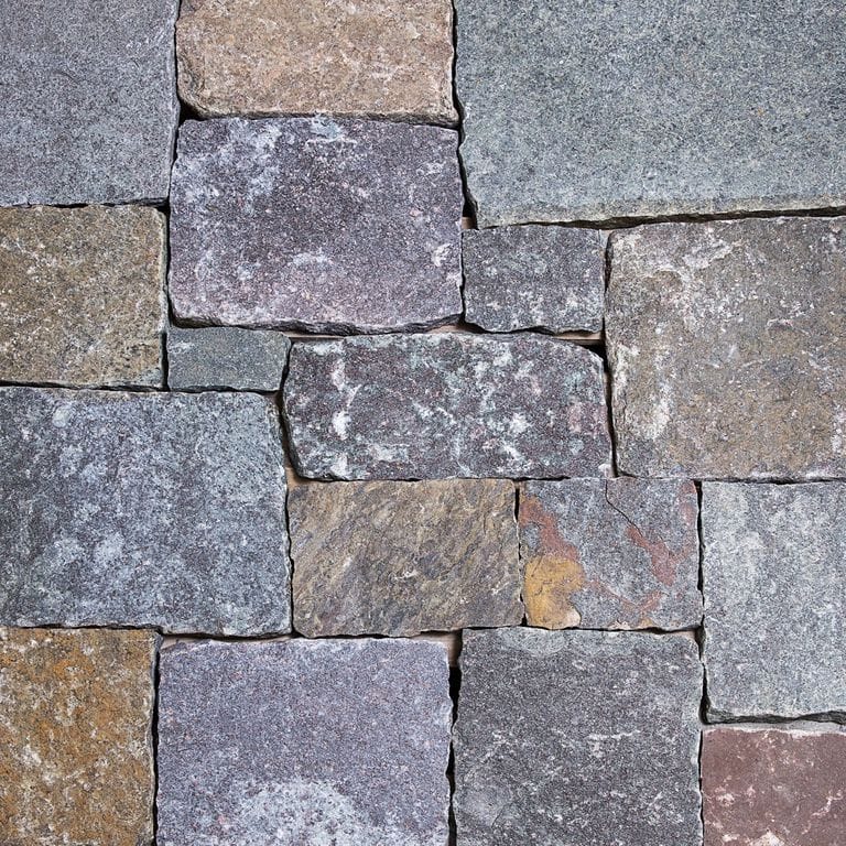 Color/Finish variation image for Lake Champlain Granite - Veneer. The image shows this product being used for full bed veneer and thin veneer. The surface finish shown is . Dominant colors shown are blue and gray; with brown, green, orange/rust, purple, white and tan secondaries. Exhibits "movement". Streaked, swirled, speckled, blotched and cloudy color patterns.