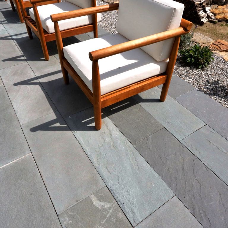 Application image for Bluestone Natural Cleft Blue/Gray - Dimensional Cut Pavers. The image shows this product being used for pool coping, patio pavers and pool deck pavers. The surface finish shown is natural cleft. Dominant colors shown are blue and gray; with a white secondary. The color mix creates a cool feeling. Regular color pattern.