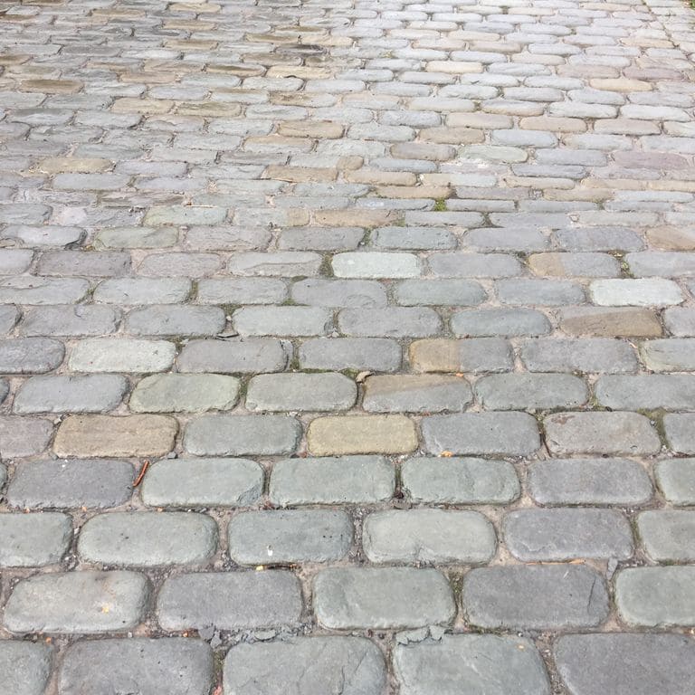 The image shows this product being used in a driveway pavers application.