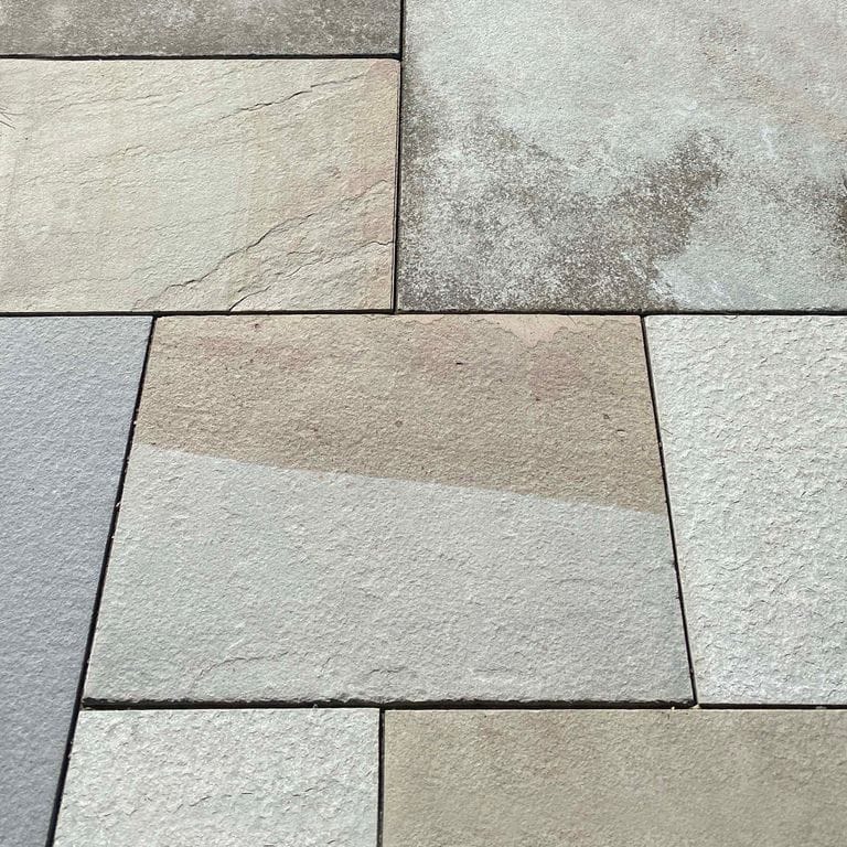 Close-up image for Bluestone Flamed Surface Full Color - Dimensional Cut Pavers. The surface finish shown is flamed. Dominant colors shown are blue, brown, green, gray, white and tan. Exhibits "movement" and the color mix creates a cool feeling. Random color pattern.