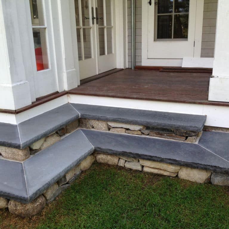 Feature image for Bluestone Flamed Surface Blue/Gray - Treads. The image shows this product being used in a treads application. Dominant colors shown are blue and gray; with a purple secondary. The color mix creates a cool feeling. Solid and cloudy color patterns.