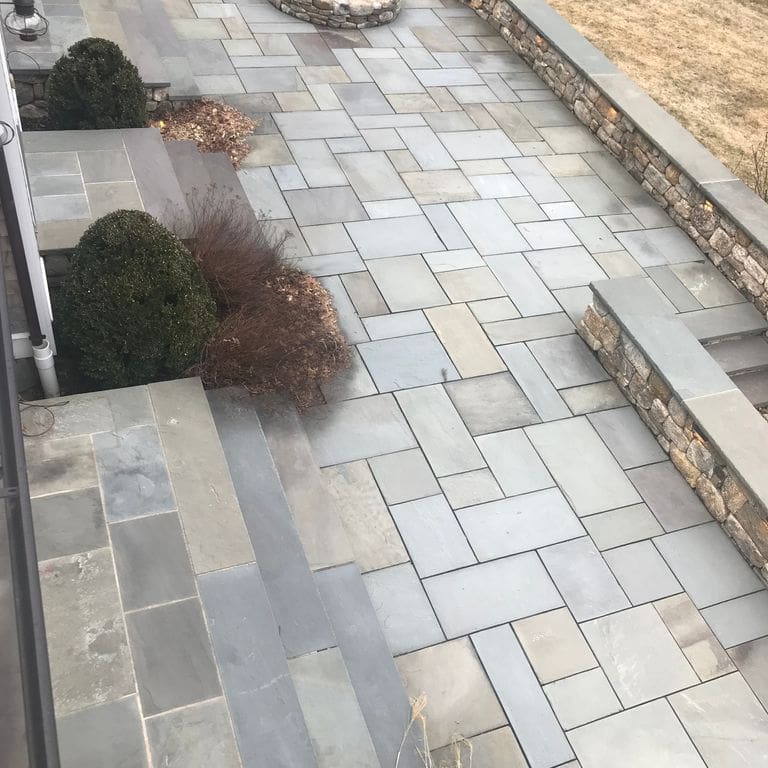The image shows this product being used in a patio pavers application.