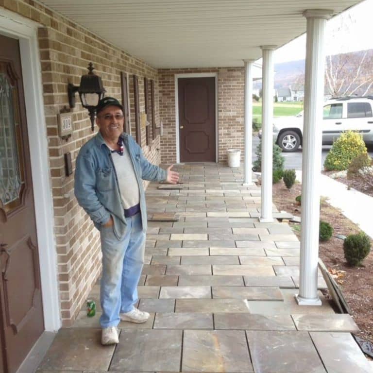 Feature image for Bluestone Natural Cleft Burgundy/Brown - Dimensional Cut Pavers. The image shows this product being used in a path pavers application. The dominant color shown is gray; with beige, orange/rust, purple, white, tan and cream secondaries. Exhibits "movement" and the color mix creates a warm feeling. Random color pattern.