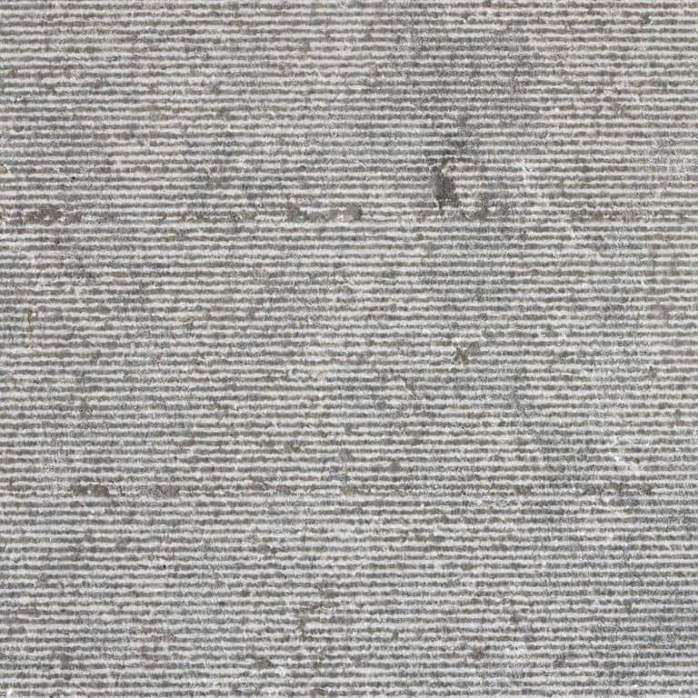 Color/Finish variation image for Dawn Haze Limestone - Treads. The surface finish shown is grooved. The dominant color shown is gray; with beige and white secondaries. The color mix creates a cool feeling. Speckled, linear and cloudy color patterns.