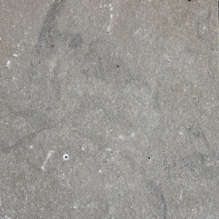 Color/Finish variation image for Dawn Haze Limestone - Veneer. The surface finish shown is flamed. The dominant color shown is gray; with beige and white secondaries. Exhibits "movement" and the color mix creates a cool feeling. Swirled and cloudy color patterns.