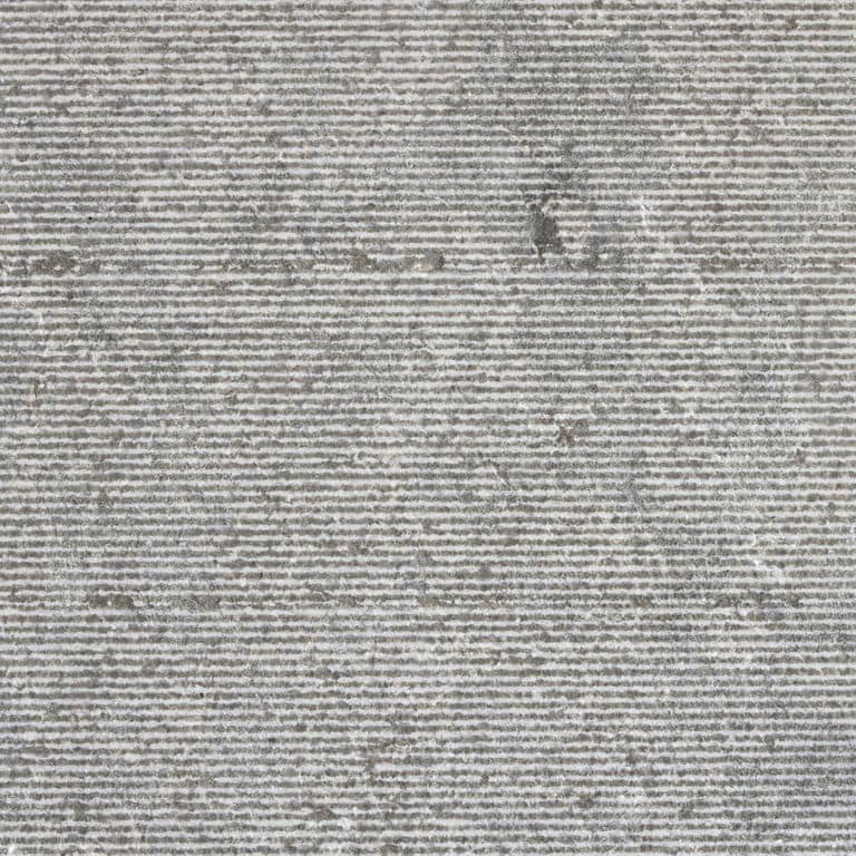 Color/Finish variation image for Dawn Haze Limestone - Veneer. The surface finish shown is grooved. The dominant color shown is gray; with beige, purple and white secondaries. The color mix creates a cool feeling. Linear and cloudy color patterns.