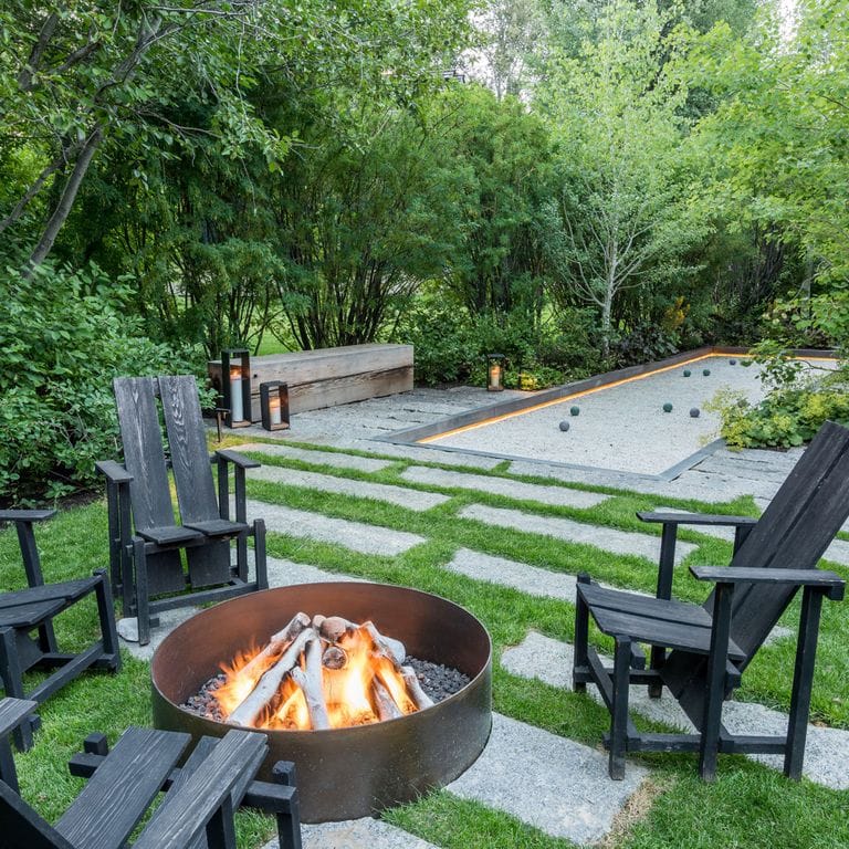 Application image for Reclaimed First Generation Curbstone - Steppers. The image shows this product being used in a patio pavers application. The surface finish shown is . The dominant color shown is gray. The color mix creates a cool feeling. Regular, speckled and coarse speckled color patterns.