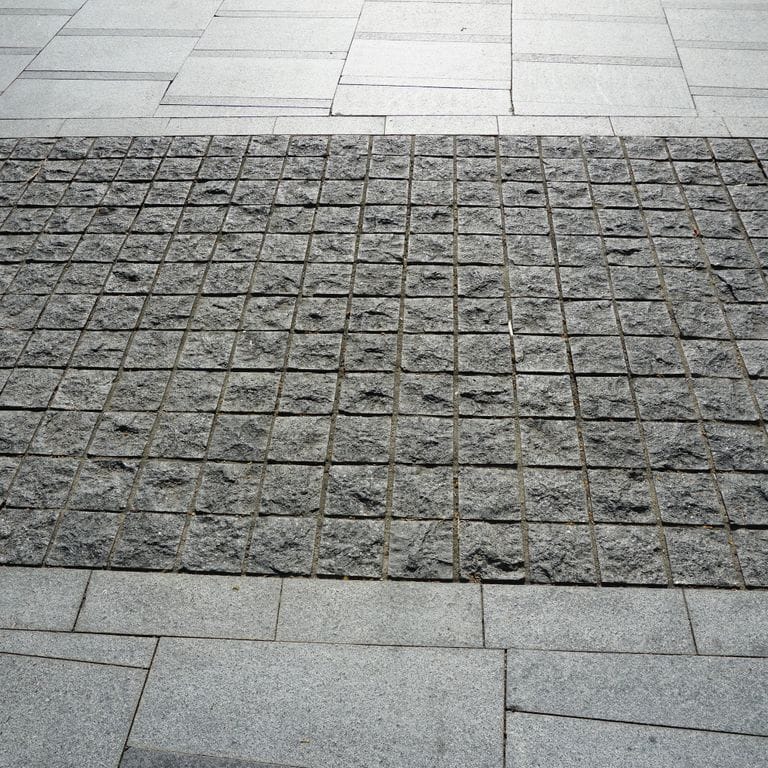 The image shows this product being used in a path pavers application.
