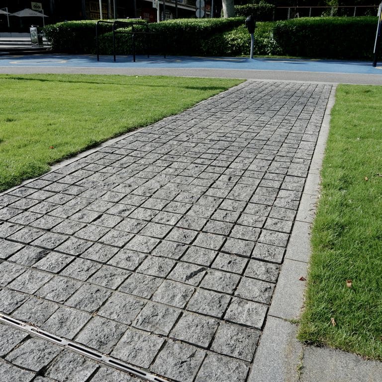 Application image for Basalt - Ankar Gray - Cobblestones. The image shows this product being used in a path pavers application. The dominant color shown is gray.